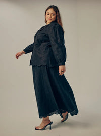 A woman dressed in All Black Tun Habiba Eyelet Set