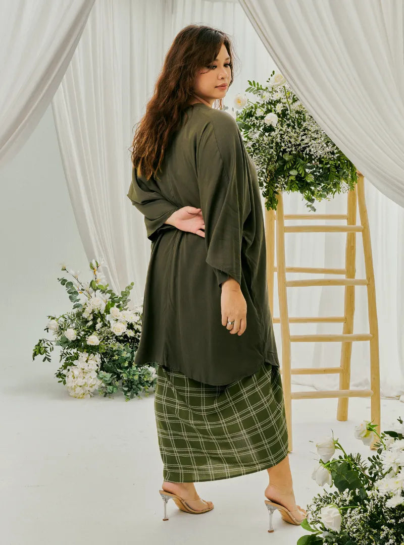 A woman dressed in Army Green Tun Bedah X Melly Gingham Pario Skirt