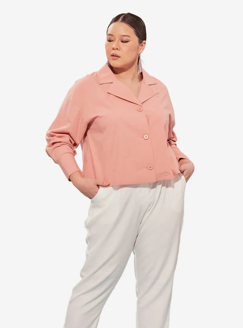 A woman dressed in Baby Salmon Cropped Shirt