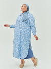 A woman dressed in Baby Blue Daisy Longline Printed Shirt Dress