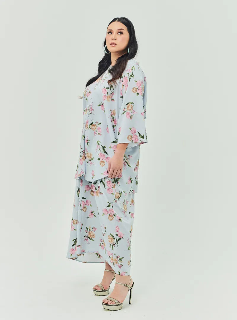 A woman dressed in Baby Blue Lily The Vintage Opah Kurung