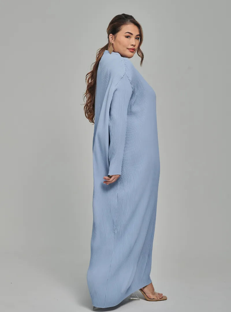 A woman dressed in Baby Blue Tun Aimellia Pleated Maxi Dress