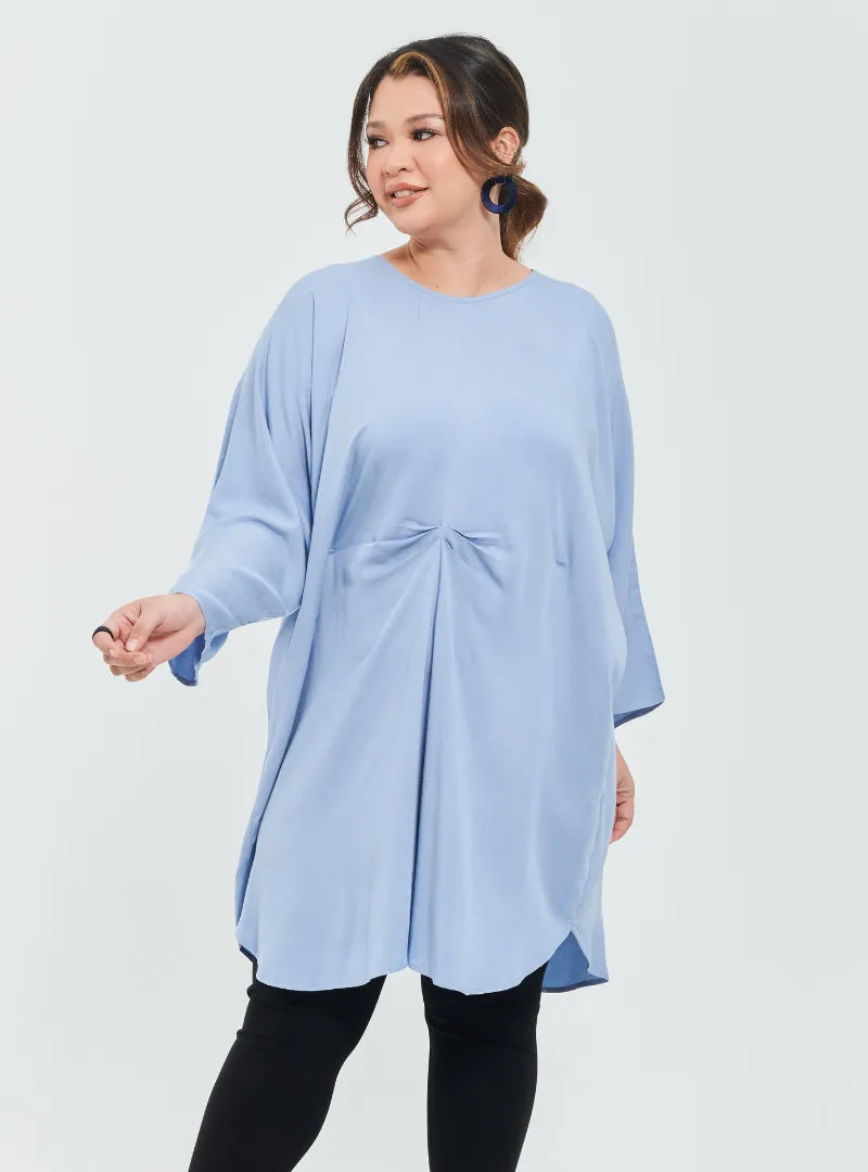 A woman dressed in Baby Blue Tun Bedah Top