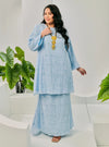 A woman dressed in Baby Blue Tun Bibah Textured Kurung