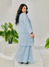 A woman dressed in Baby Blue Tun Bibah Textured Kurung