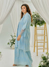 A woman dressed in Baby Blue Tun Farah Embroidered Eyelet Kurung