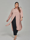 A woman dressed in Baby Salmon Longline Oversized Cotton Shirt Dress