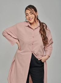 A woman dressed in Baby Salmon Longline Oversized Cotton Shirt Dress