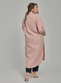 A woman dressed in Baby Salmon Longline Oversized Cotton Shirt Dress