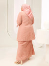 A woman dressed in Baby Salmon Tun Maryam Eyelet Kurung