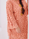 A woman dressed in Baby Salmon Tun Sharifah Lace Kurung