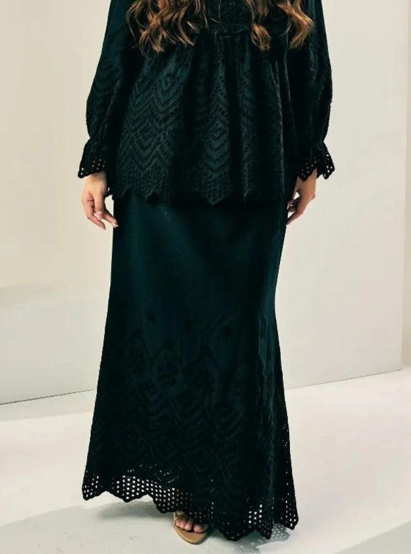 A woman wearing Black Ezzah Eyelet Doll Skirt