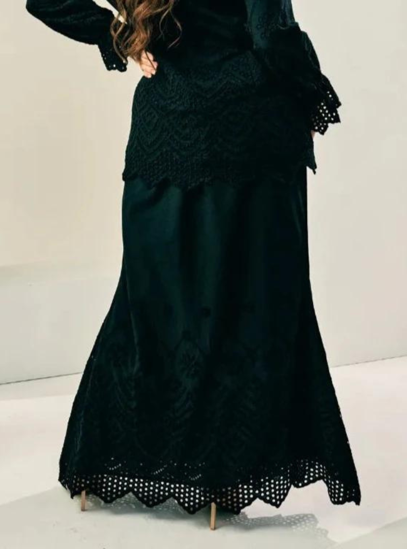 A woman wearing Black Ezzah Eyelet Doll Skirt