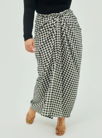 A woman wearing Black Instant Checked Pario Wrap Skirt Only