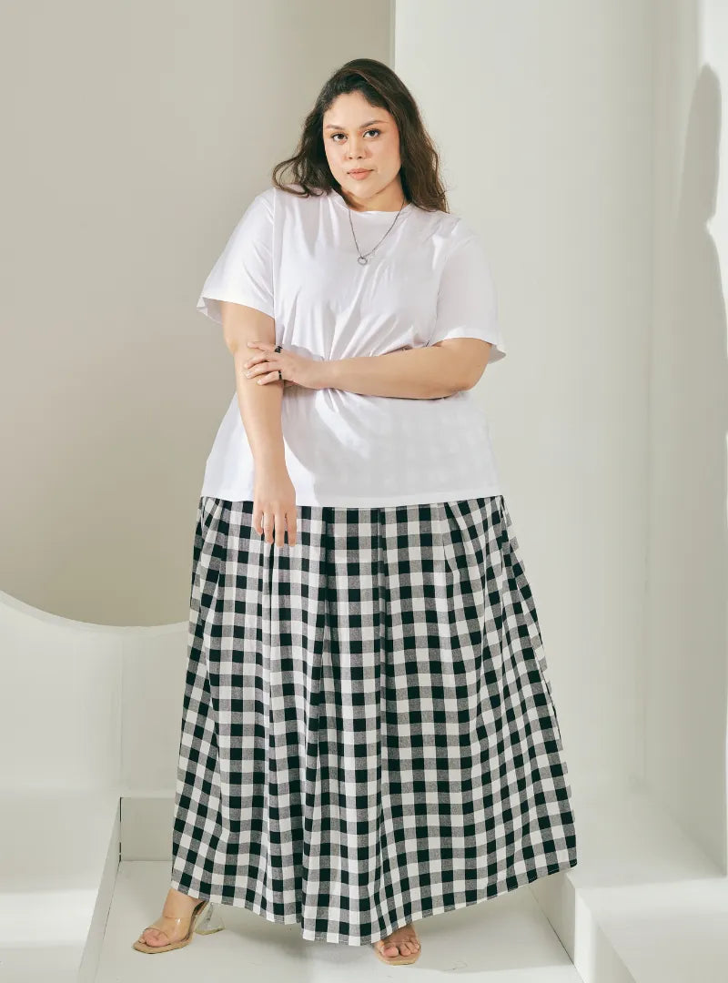 A woman wearing Black Jane Checked Skirt