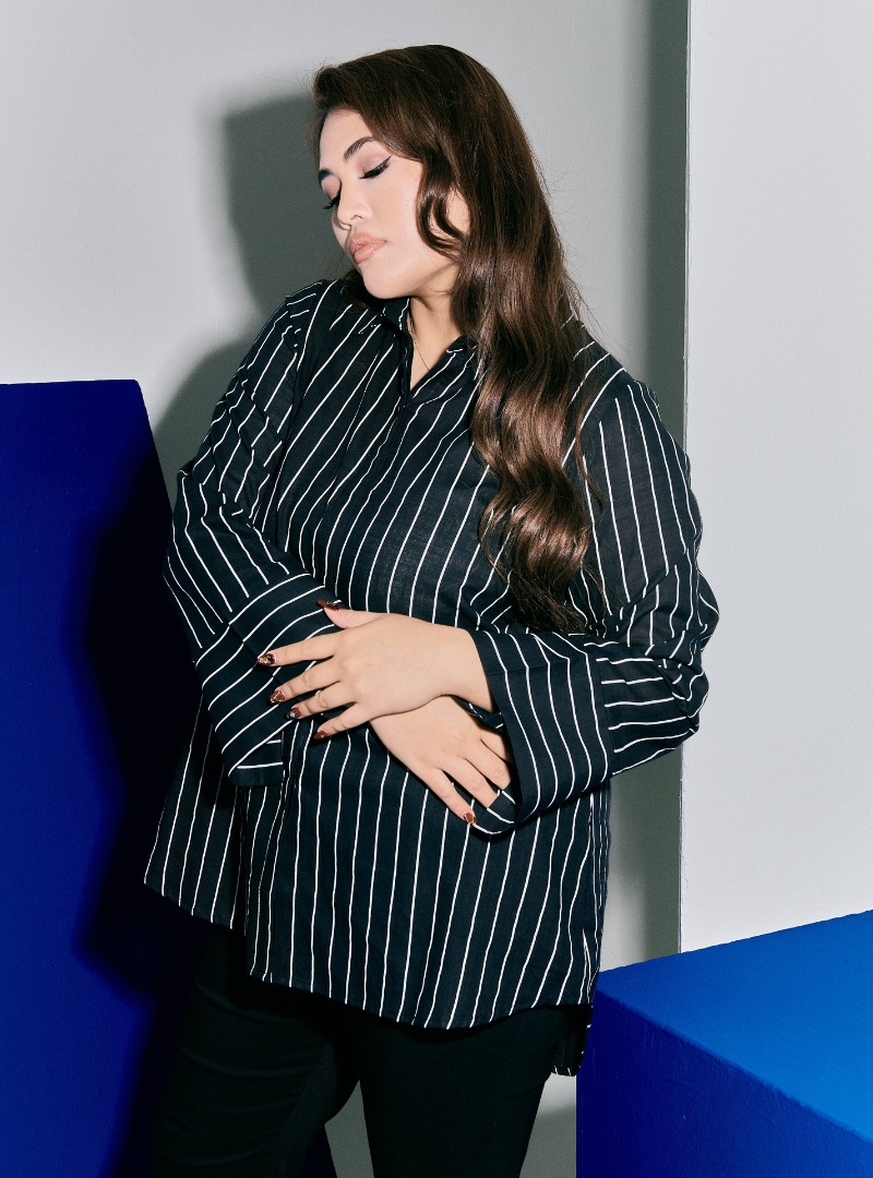 A woman wearing Black Janiper Striped Shirt