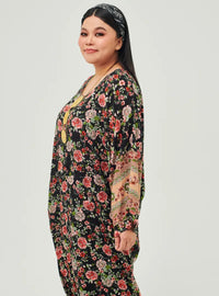 A woman dressed in Black Kerawang Essential Front Knot Kaftan