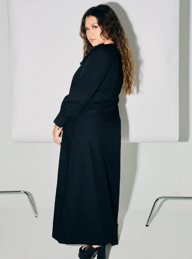 A woman dressed in Black Marsya Cotton Long Sleeve Dress