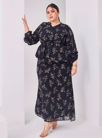 A woman dressed in Black Padi Tun Umaiyah Padi Chiffon Wrap Kurung