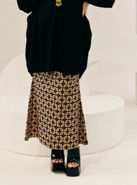 A woman wearing Black Timor Print Songket Skirt