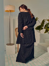 A woman dressed in Black Tun Bibah Textured Kurung