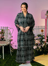 A woman dressed in Black Tun Farah Embroidered Eyelet Kurung