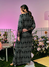 A woman dressed in Black Tun Farah Embroidered Eyelet Kurung