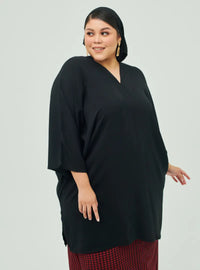 A woman dressed in Black Tun Fatima Kaftan Top