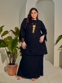 A woman dressed in Black Tun Kiambang Striped Cotton Lace Kurung