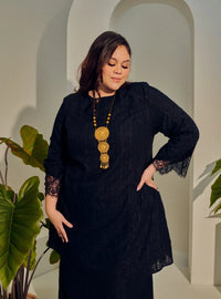 A woman dressed in Black Tun Kiambang Striped Cotton Lace Kurung