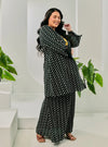 A woman dressed in Black Tun Maryam Eyelet Kurung