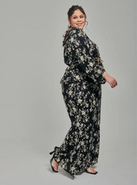 A woman dressed in Black Tun Sarah 3D Chiffon Wrap Kurung