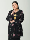 A woman dressed in Black Tun Zahira Naabi Lace Kurung