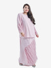 A woman dressed in Blush Pink Lalang Feather Kurung