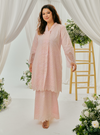 A woman dressed in Blush Pink Tun Farah Embroidered Eyelet Kurung