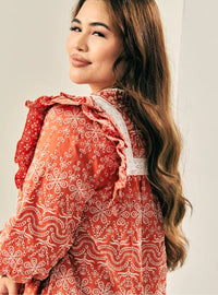 A woman dressed in Brick Orange Miza Cotton Broderies Eyelet Top