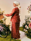 A woman dressed in Brick Orange Tun Anisah Kebaya Kurung