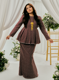 A woman dressed in Burgundy Tun Zera Eyelet Kurung