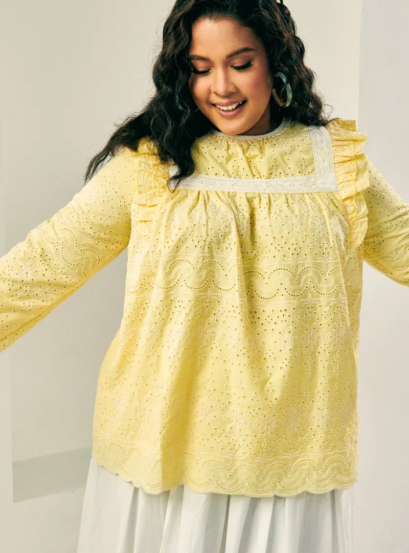 A woman dressed in Butter Miza Cotton Broderies Eyelet Top