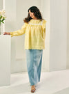 A woman dressed in Butter Miza Cotton Broderies Eyelet Top