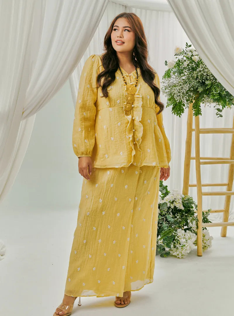  A woman dressed in Butter Tun Anisah Kebaya Kurung