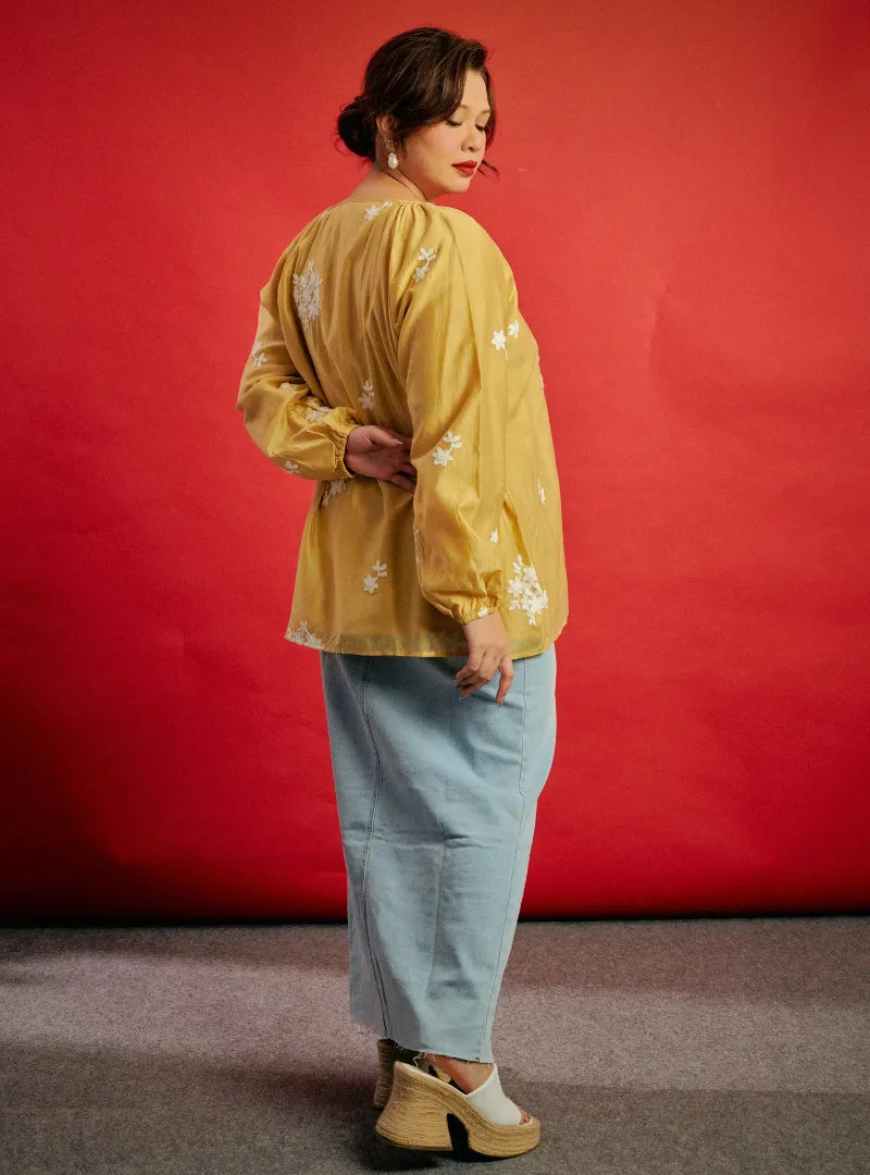 A woman dressed in Buttercorn Wong Gu Embroidered Cheongsam Top