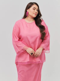 A woman dressed in Candy Pink Tun Aminah Organza Basic Kurung