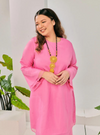 A woman dressed in Candy Pink Tun Sharimah Organza Kurung