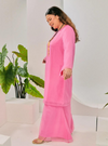 A woman dressed in Candy Pink Tun Sharimah Organza Kurung