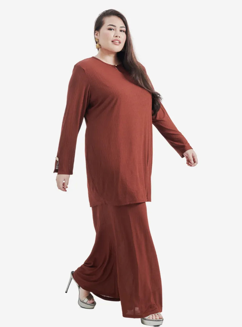 A woman dressed in Caramel Khatijah Bodycon Kurung