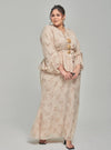 A woman dressed in Champagne Padi Tun Umaiyah Padi Chiffon Wrap Kurung