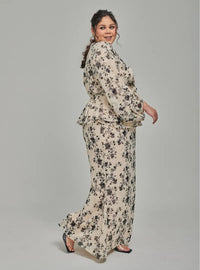 A woman dressed in Champagne Tun Sarah 3D Chiffon Wrap Kurung