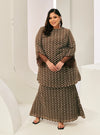 A woman dressed in Chocolate Tun Maryam Eyelet Kurung