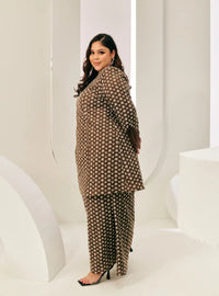 A woman dressed in Chocolate Tun Maryam Eyelet Kurung